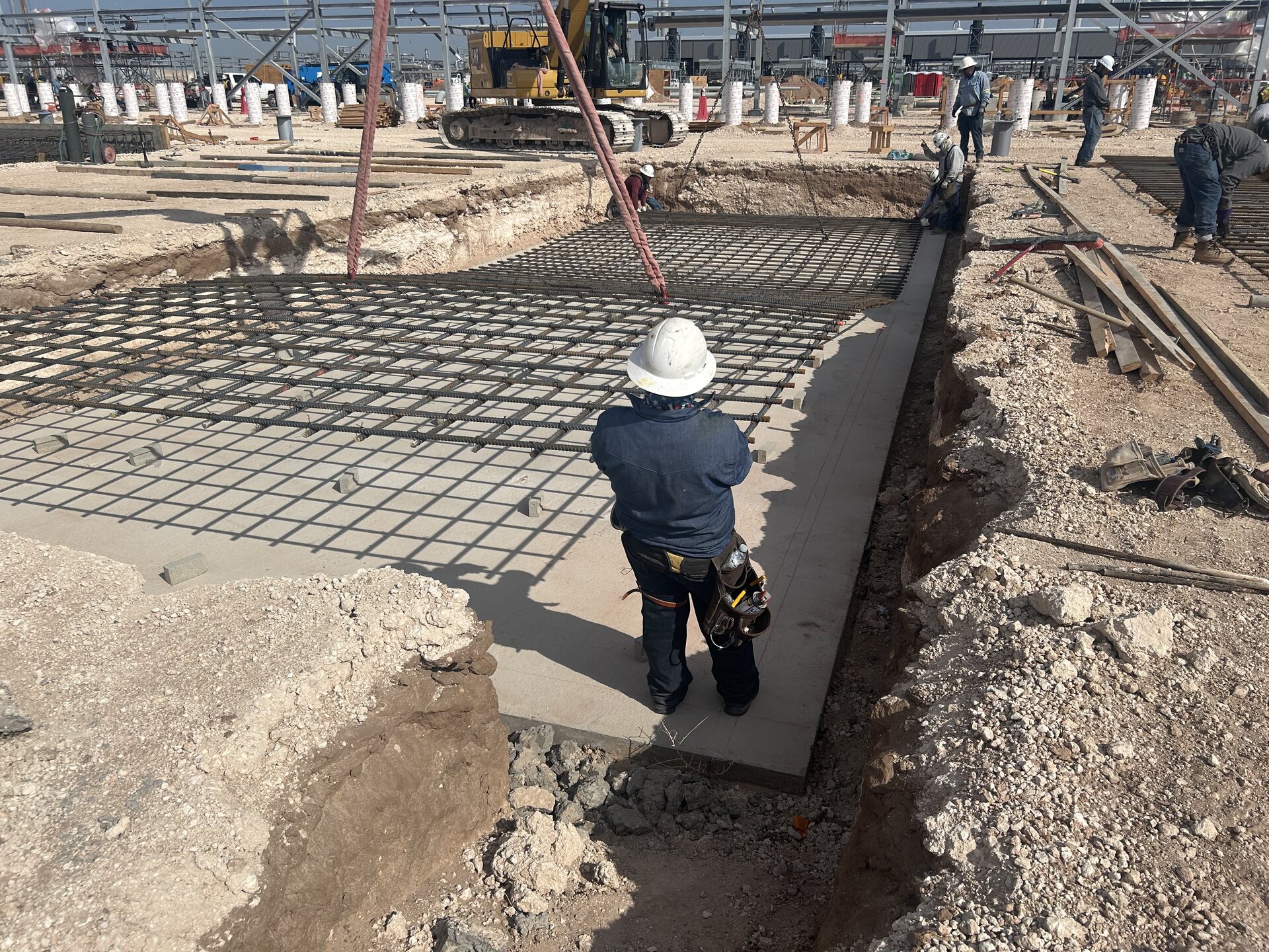 Vector team member inspecting industrial foundation work