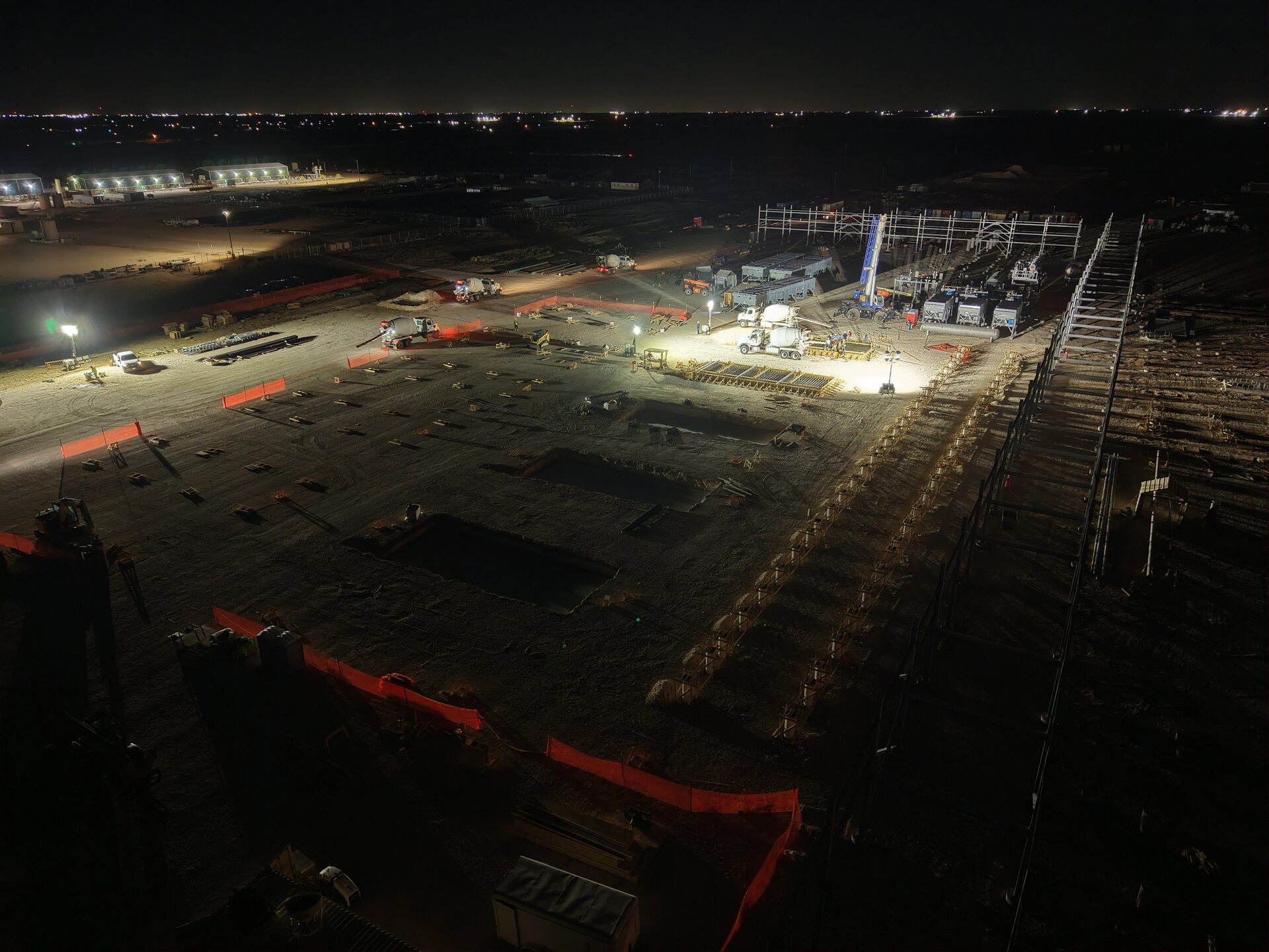 Industrial foundation construction underway at night