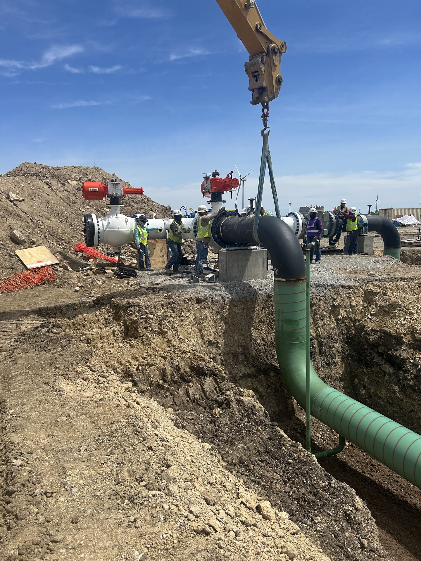 Field crew guiding pipeline equipment into position