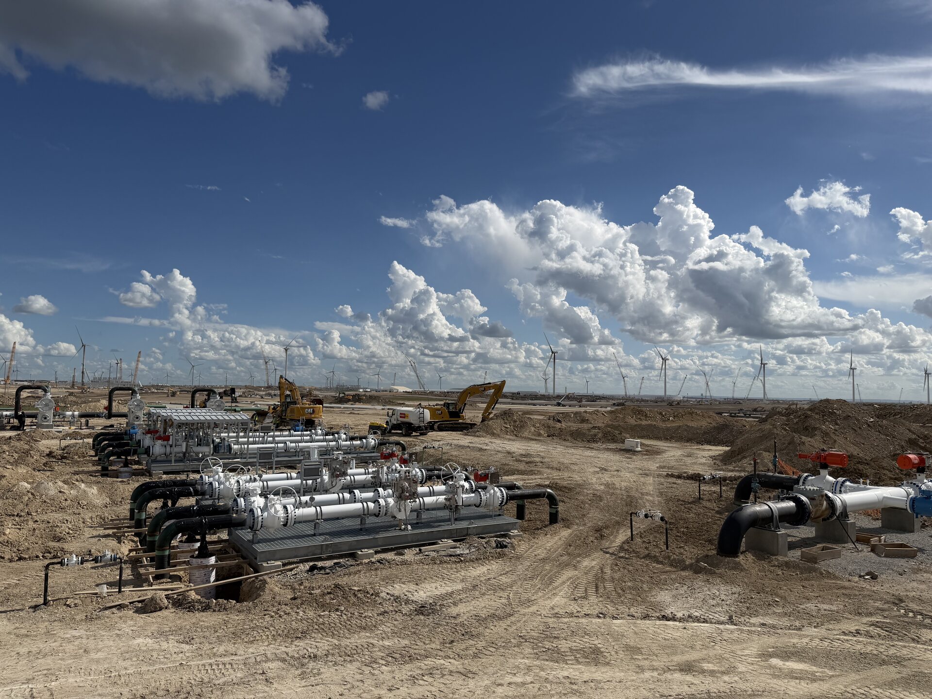Multi-run meter station under a wide Texas sky